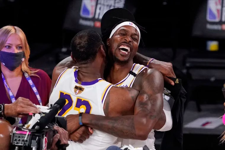 Dwight Howard (right) celebrates with Lakers teammate LeBron James after the Lakers defeated the Miami Heat to win the NBA championship in October.