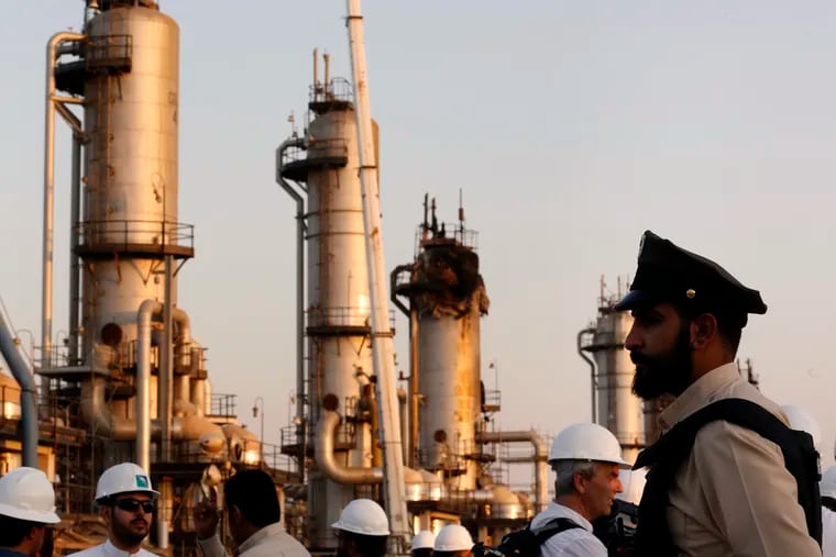 During a trip organized by Saudi information ministry, a security guarder stands alert in front of Aramco's oil processing facility after the recent Sept. 14 attack on Aramco's oil processing facility in Abqaiq, near Dammam in the Kingdom's Eastern Province, Friday, Sept. 20, 2019.