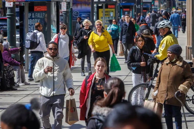 Pedestrians walking along Market Street at Eighth Street in Center City. The number of nonresident workers in the city on an average weekday was 14% higher in April 2023 than in April 2022.