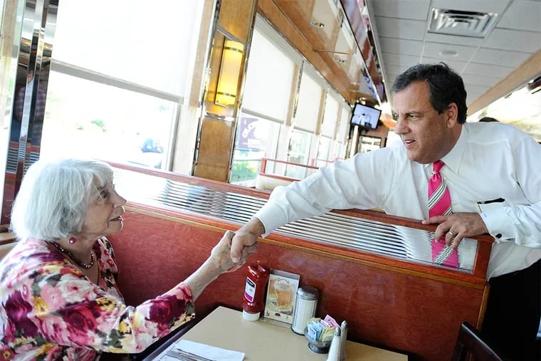 New Jersey Gov. Chris Christie, right, greets Ernestine Durrell of Greenwich, during a visit to a diner with Connecticut Republican gubernatorial candidate Tom Foley, Monday, July 21, 2014 in Greenwich, Conn. (AP Photo/Jessica Hill)