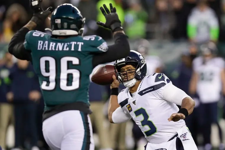 Seattle Seahawks quarterback Russell Wilson throws the football past Eagles defensive end Derek Barnett during the first-quarter in a NFC Wild Card playoff game in January.