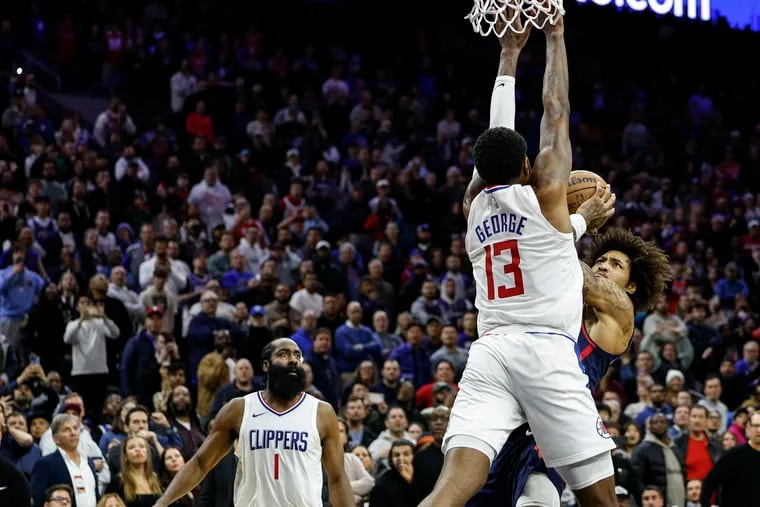 Kelly Oubre Jr. of the Sixers goes up against the Clippers' Paul George with seconds left in the game on March 27. The clock ran out as the Clippers held on for a 108-107 win at the Wells Fargo Center.