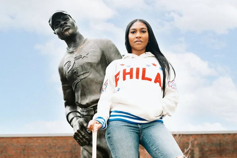 A model wears a red, white, and blue Philadelphia Stars-inspired hoodie, part of a collaboration between Philly-based apparel brand For The Culture and Ebbets Field Flannels.