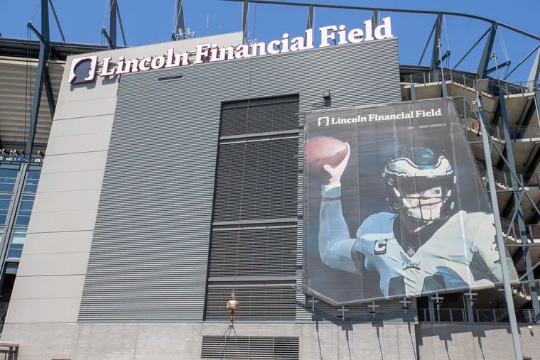 A banner featuring former Eagles quarterback Carson Wentz remained prominently displayed outside Lincoln Financial Field.