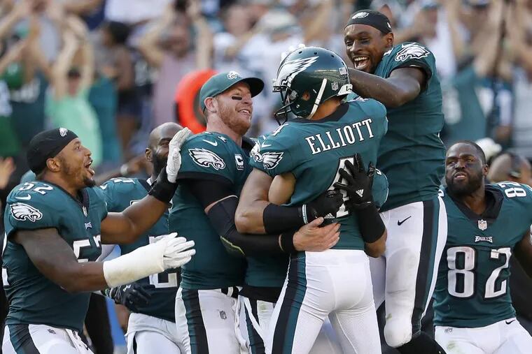 Eagles’ Carson Wentz, second from left, and Alshon Jeffery, right, celebrate with Jake Elliott, center, after kicking the game winning field goal as the Philadelphia Eagles win 27-24 over the New York Giants in Philadelphia, PA on September 24, 2017. DAVID MAIALETTI / Staff Photographer