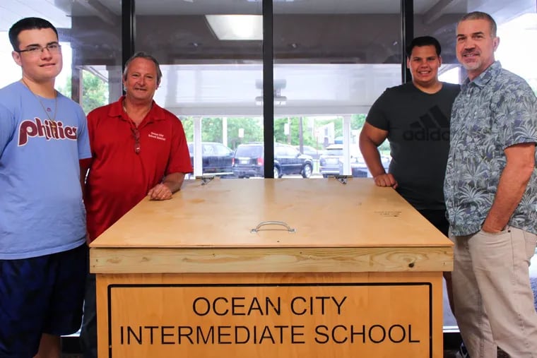 Todd Lauer (red shirt), building supervisor for the Ocean City Intermediate School, is spearheading a food drive this summer to collect nonperishable foods from tourists with unopened fares leftover from their summer vacation.