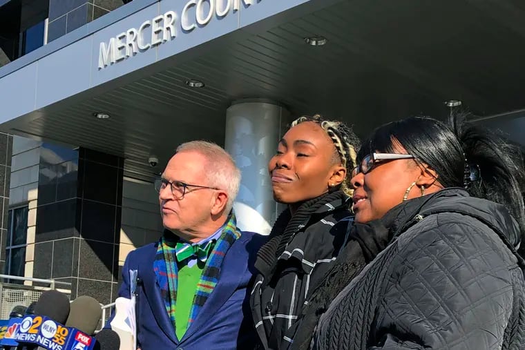 FILE - In this Dec. 12, 2018, file photo, Jazmine Headley, center, joins attorney Brian Neary and her mother, Jacqueline Jenkins, outside a courthouse in Trenton, N.J., after she accepted a deal to enter a pretrial intervention program related to credit card theft charges she faced. Headley, who had her toddler yanked from her arms by New York police in a widely seen video said in an interview published on Sunday that she went into "defense mode." (AP Photo/Mike Catalini, File)