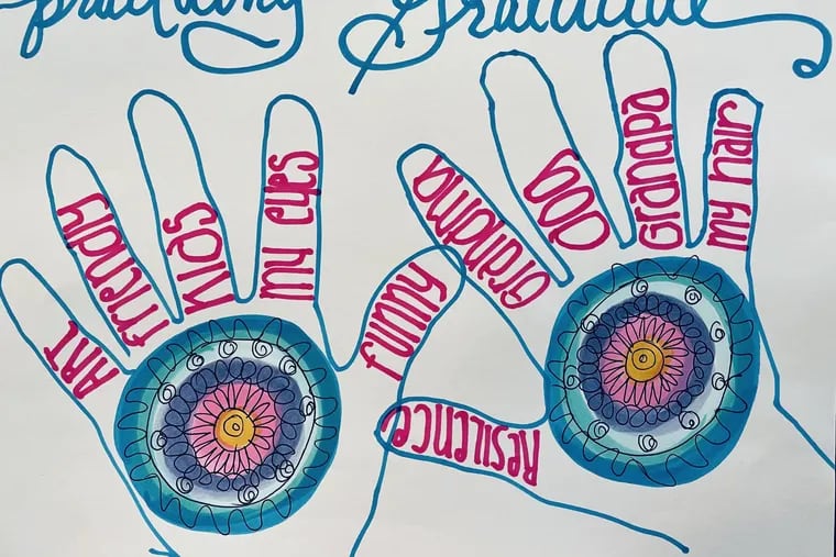 Linda Baker, art therapist at Princeton House Behavioral Health, draws her hands as a gratitude exercise.