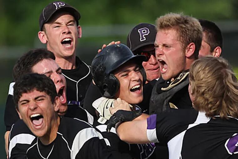 Phoenixville's Tom Kawchak, center, is mobbed by teammates after hitting the game-winning run in the seventh inning. (Michael Bryant/Staff Photographer)
