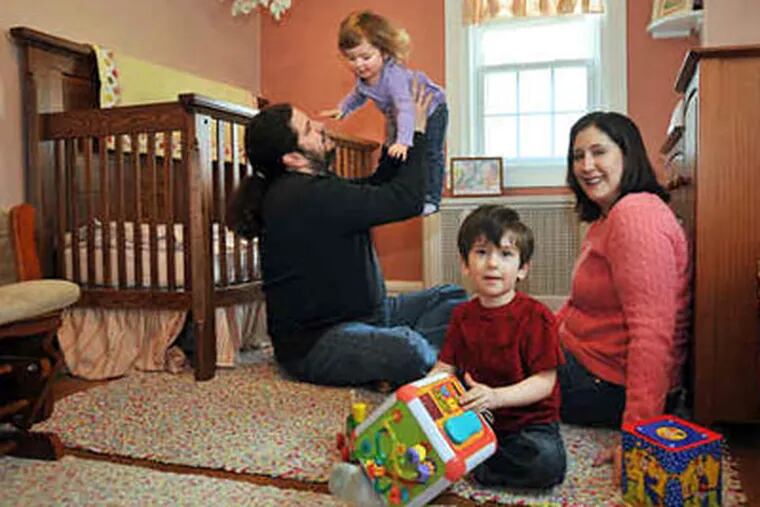 Steve and Amy Jo Bader of Bala Cynwyd play with daughter Lucy, 18 months, and son Sam, 3. Bader is expecting and hopes for a sister for Lucy, though not in "an all-or-nothing kind of way," she says. (Sharon Gekoski-Kimmel / Staff Photographer)