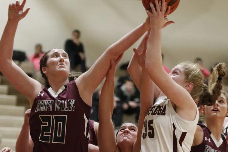Emily McAteer (left) of Garnet Valley battles for a rebound with Liz Scott (center) and Emma Powell (2nd from right) of Conestoga in the 1st quarter of a girls basketball game on Jan 18, 2017.