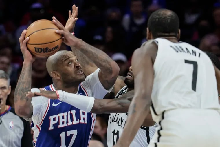 The Sixers' P.J. Tucker attempts a shot as the Nets' Kyrie Irving defends at the Wells Fargo Center in Philadelphia, Tuesday, November 22, 2022.
