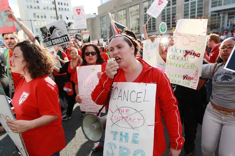 PHOTOS: MICHAEL BRYANT / STAFF PHOTOGRAPHER Kristin Combs (center), a teacher at Penn Treaty, chants with union supporters to protest the SRC's decision to cancel the teachers union contracts.