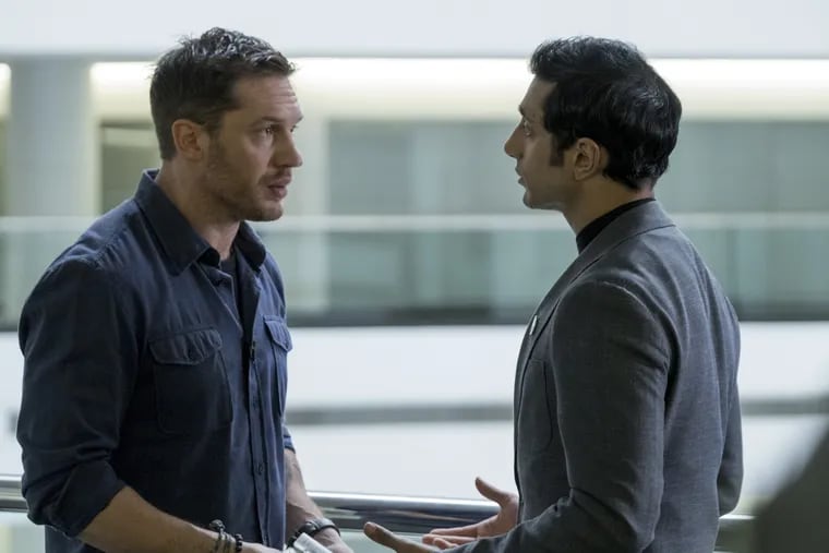 Tom Hardy, left, and Riz Ahmed in a scene from 'Venom.'