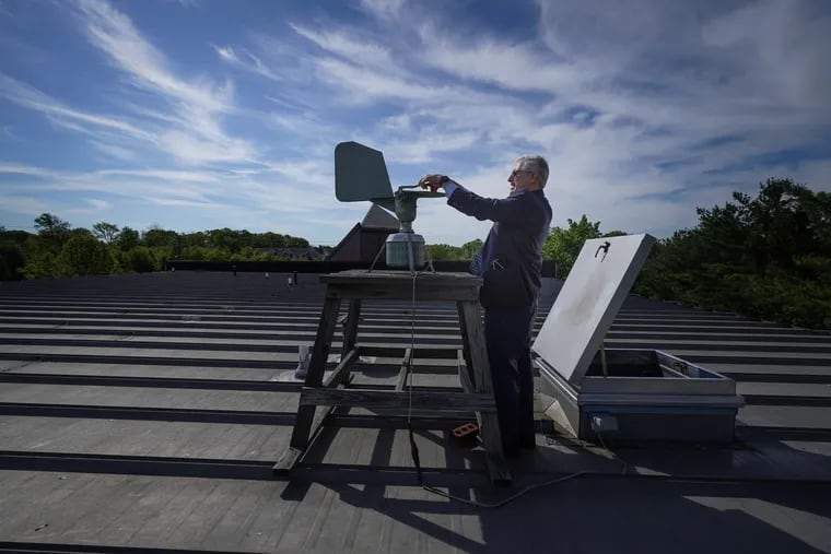 Donald Dvorin collects a pollen sample from a trap on the roof of his practice in Mount Laurel in May 2021.