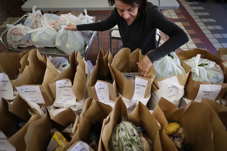 Rosemary Noce-Murphy loads up bags at Old Pine Community Center in Philadelphia, Pa. for a grocery delivery program that focuses on immigrant families in South and Southwest Philadelphia on Sunday, March 17, 2024.