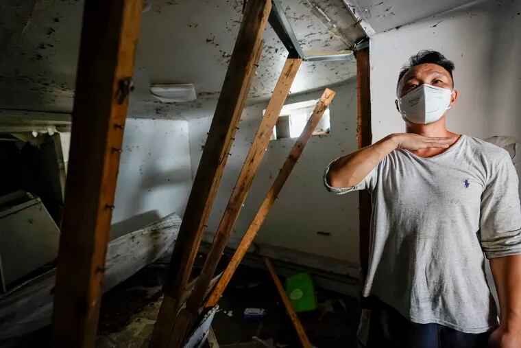 Danny Hong shows where the water reached up to him as he shows the damage in his basement apartment in the Flushing neighborhood of the Queens borough of New York.