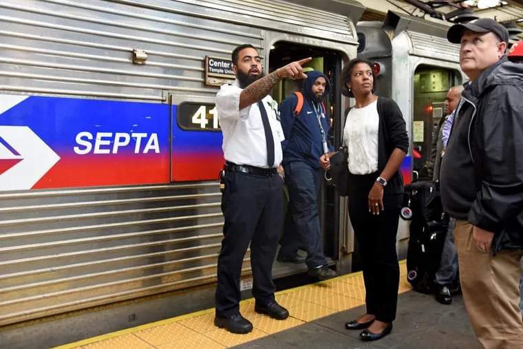 A SEPTA Regional Rail conductor (who declined to give his name at the time) helps commuters at 30th Street Station during evening rush hour on the third day of the 2016 SEPTA strike.