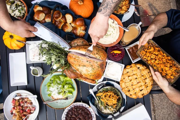 Garces Events' Thanksgiving dinner spread includes herb-roasted turkey, Parker House rolls with apple butter, and cranberry relish.
