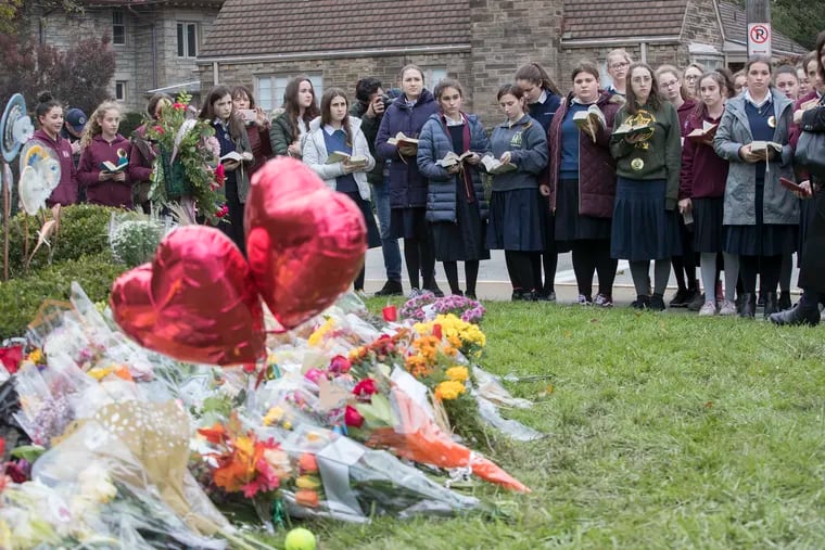 Girls from the Yeshiva School of Pittsburgh gather to sing and pray at the memorial outiside of the Tree of Life Synagogue in Pittsburgh last October. The memorial was for the 11 people that were killed at the shooting the synagogue.