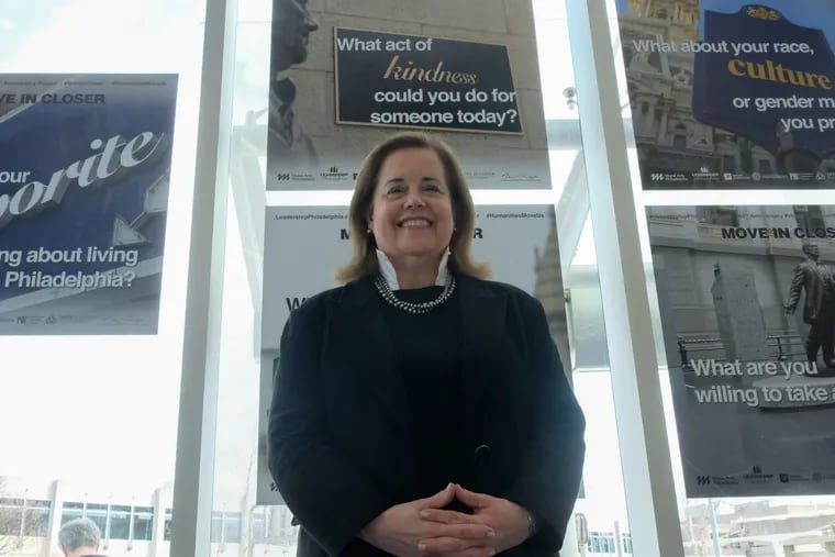 Liz Dow, head of Leadership Philadelphia, stands in front of public art mural at Philadelphia International Airport on Friday, March 15, 2019.