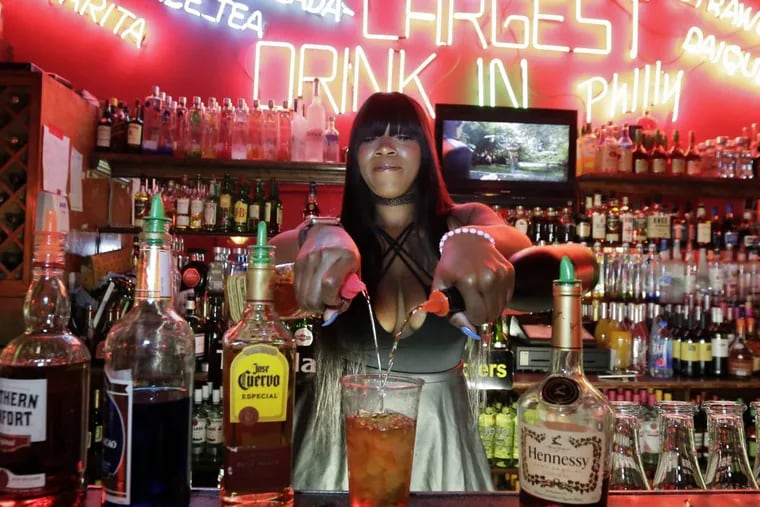 Bartender Eddira Bazemore makes a Dark Trash Can at the Eagle Bar.