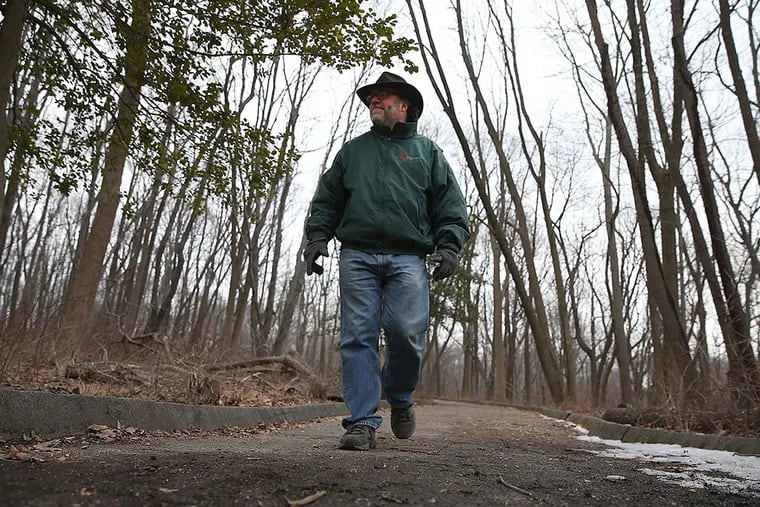 Mike Weilbacher , in search of early signs of spring along the Schuylkill Center's six miles of trails. DAVID MAIALETTI / STAFF PHOTOGRAPHER