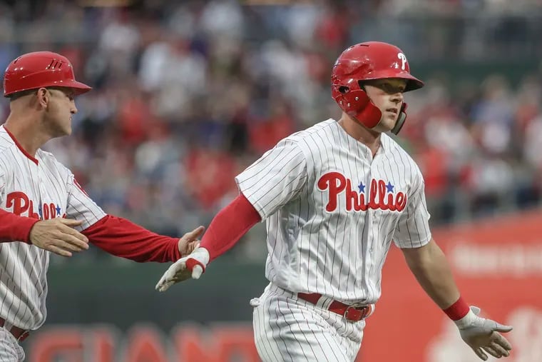 Phillies' leftfielder Rhys Hoskins rounds third base and passes coach Dusty Wathan after his three-run homer against the Yankees on Wednesday.
