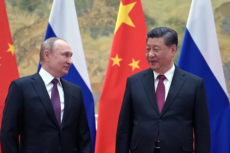 Russian President Vladimir Putin (left) and Chinese President Xi Jinping pose for a photograph during their meeting in Beijing, on Feb. 4, 2022.