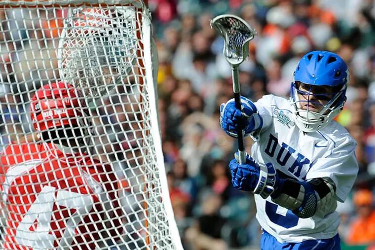 Duke's Case Matheis (right) takes a shot against Cornell goalie AJ Fiore (47) during the second half of an NCAA college Division 1 semifinal lacrosse game on Saturday, May 25, 2013, in Philadelphia. Duke won 16-14. (Michael Perez/AP)