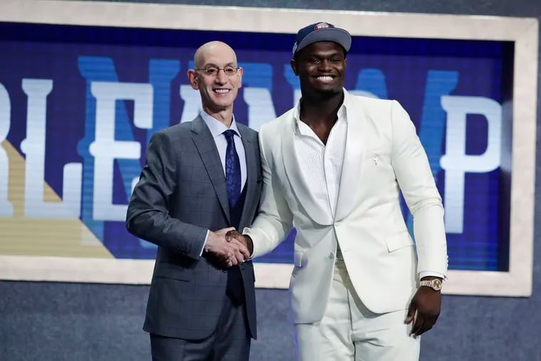 Duke's Zion Williamson, right, poses for photographs with NBA Commissioner Adam Silver after being selected by the New Orleans Pelicans as the first pick during the NBA basketball draft Thursday, June 20, 2019, in New York. (AP Photo/Julio Cortez)
