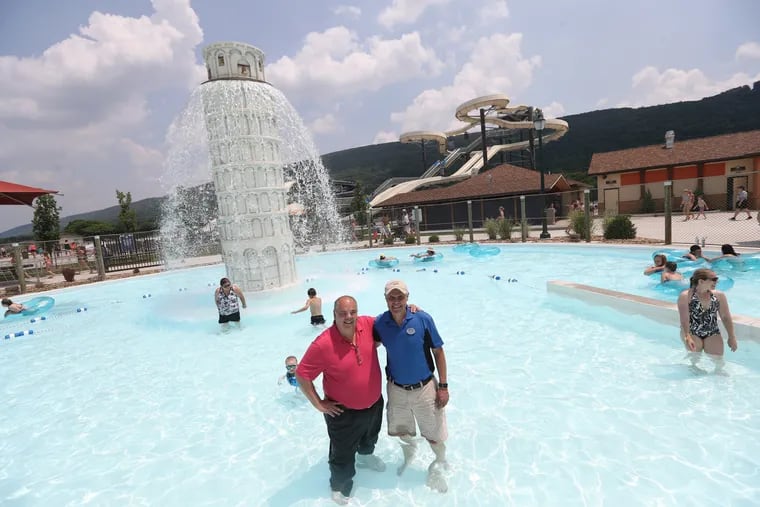 There's pizza, pasta sauce and this Leaning Tower of Pisa replica at DelGrosso's Park in Tipton, Pa., a family-owned amusement complex right next door to the sauce factory run by DelGrosso Foods.<br/>
We coaxed a fully-clothed foods division CEO Joe DelGrosso, left, to wade into the water park for a picture with his cousin, amusement division chief Carl Crider Jr., on  Monday June 18, 2018. DAVID SWANSON / Staff Photographer