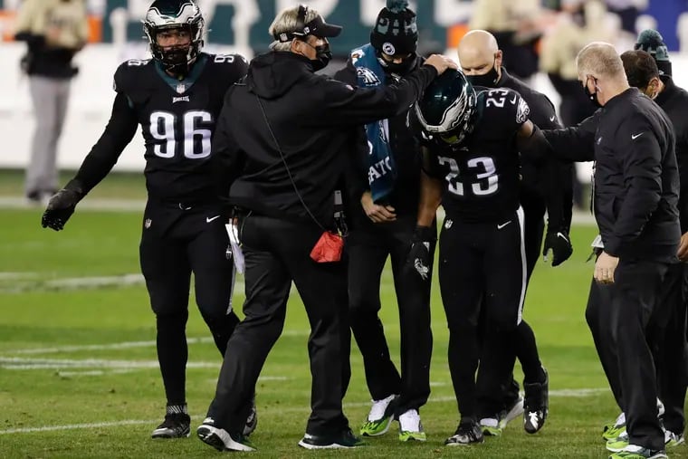 Doug Pederson consoles Rodney McLeod, who leaves the field Sunday, limping heavily.