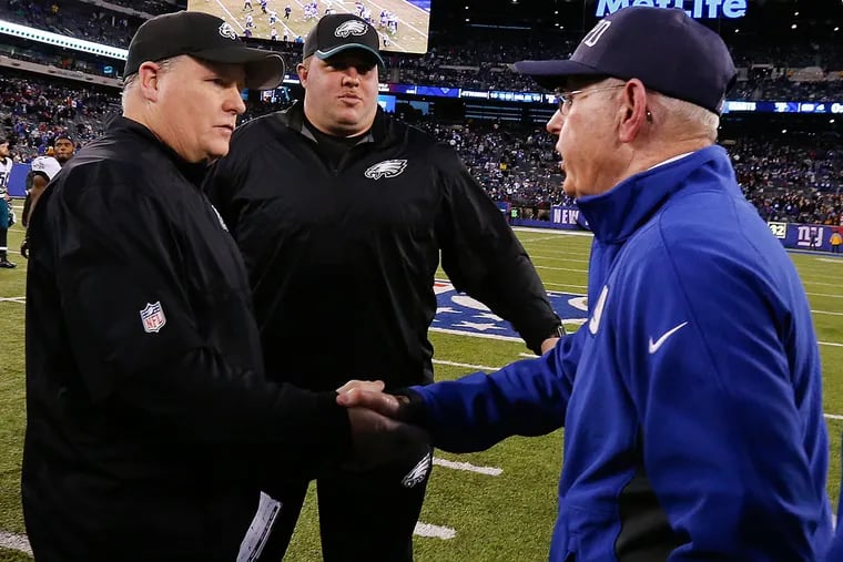 Philadelphia Eagles head coach Chip Kelly, left, and New York Giants
head coach Tom Coughlin, right, shake hands after an NFL football game Sunday, Dec. 28, 2014, in East Rutherford, N.J. The Eagles won the game 34-26.