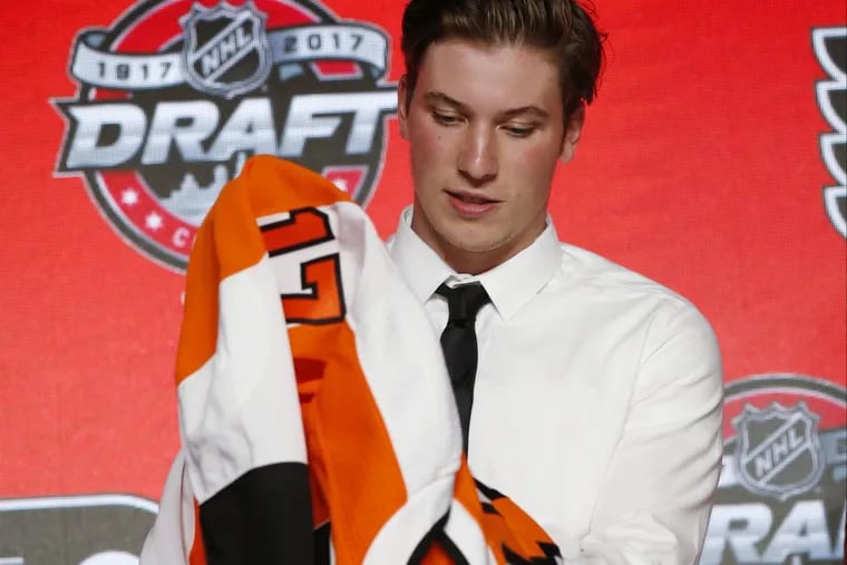 Nolan Patrick tries on a Flyers jersey at the June draft prior to developing an infection on his face.