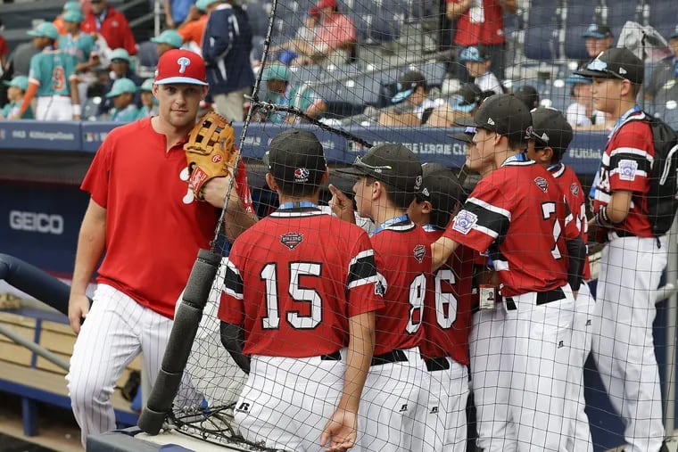 Rhys Hoskins talks with members of the Canadian Little League team ahead of the Phillies game vs. the Mets in Williamsport, Pa., on Sunday. The two NL East teams are playing as part of the Little League Classic, which is in its second year.