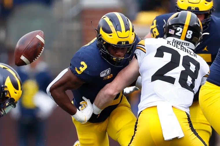 Michigan running back Christian Turner (3) fumbled as Iowa defensive back Jack Koerner (28) made a tackle during the first half of the teams' Oct. 5 game.