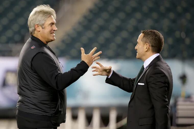 Eagles coach Doug Pederson, left, talking with Howie Roseman before a November game.