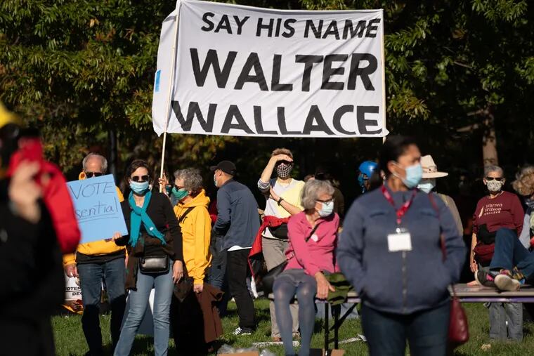 Protestors gather to listen to speakers at the Independence Visitor Center prior to marching to City Hall, in Philadelphia, November 04, 2020. The protestors hold a sign calling for remembrance of Walter Wallace. The stated objective of the protest was calling for acceptance of the results of the 2020 election, to have every vote counted, and a peaceful transition of power.