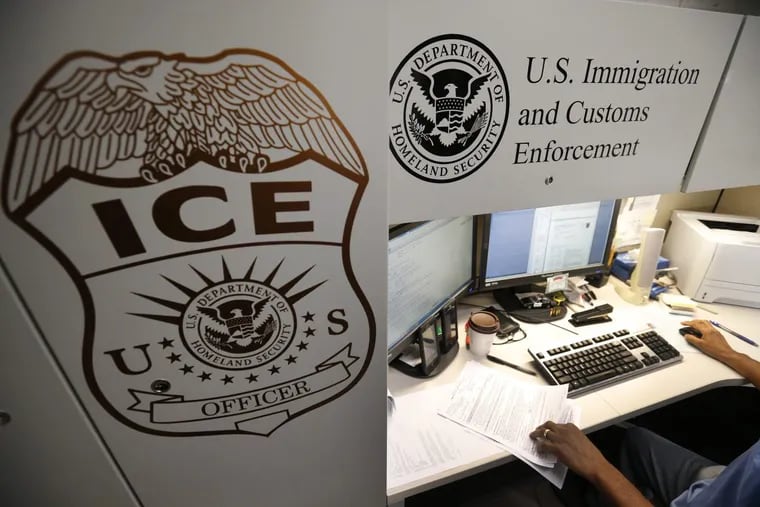 An unidentified Immigration and Customs Enforcement deportation officer reviews forms required to issue a detainer asking local law enforcement to hold someone until ICE agents can pick up the person, in this 2017 photo at the Pacific Enforcement Response Center in California.