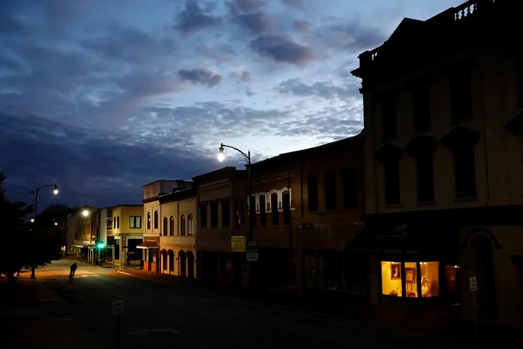 In this Oct. 28, 2017, file photo the storefront window of a portrait studio is lit up along a downtown street at dusk in Lumberton, N.C. Cash is one of the most important indicators for the health of small businesses. AP Photo/David Goldman, File