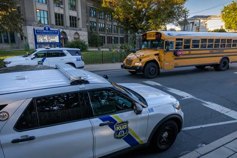 Philadelphia police vehicles along Ridge Avenue outside Roxborough High School on Wednesday, the morning after a shooting in which one student was killed and four others were wounded after a football scrimmage.