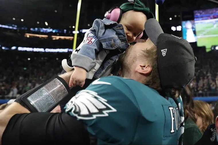 Eaglesâ€™ Nick Foles, right, kisses his daughter, Lilly, after the Philadelphia Eagles win 41-33 over the New England Patriots in the Super Bowl in Minneapolis, MN on February 4, 2018. DAVID MAIALETTI / Staff Photographer