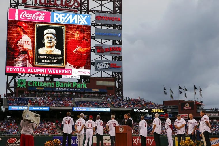 Phillies Wall of Fame members watch a tribute for catcher Darren Daulton before the Phillies played the Mets on Saturday.