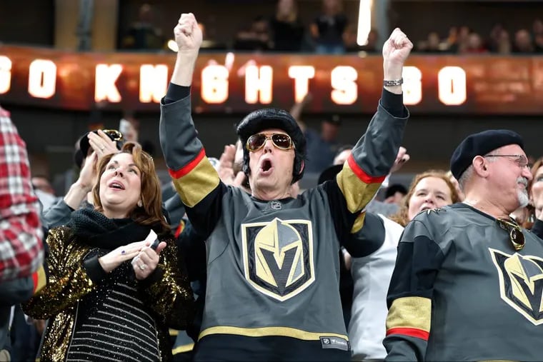 L A Golden Knights fan with Elvis hair celebrates a goal during a home game against the Edmonton Oilers.