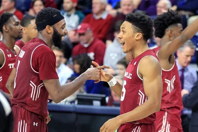Josh Brown and Nate Pierre-Louis of Temple  celebrate after the victory over Penn at the Palestra.