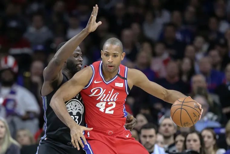 The Sixers' Al Horford drives on the Golden State Warriors' Draymond Green.