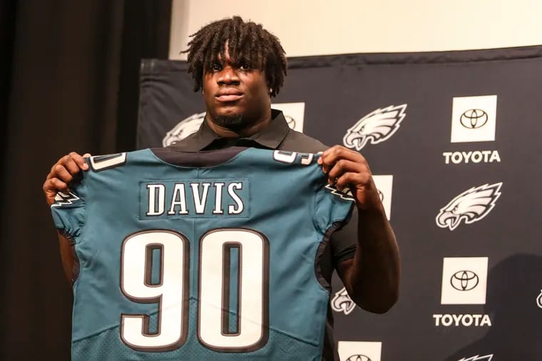 Eagles introducing first-round draft pick Jordan Davis holding his jersey at the Nova Care Center on Friday.