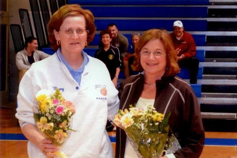 Mary Scharff (left), a former Paul VI basketball star, stands with former Paul VI coach Vicki Orzechowski.
