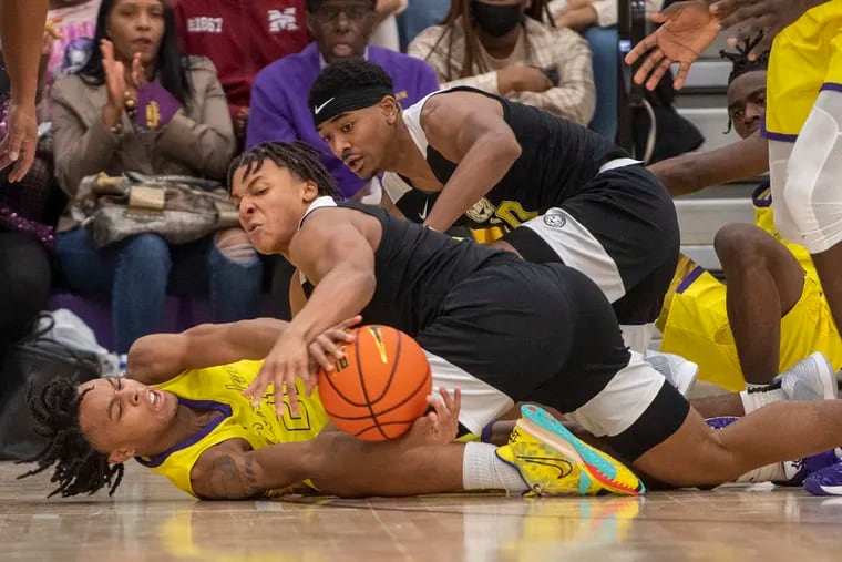 Camden High School star D.J. Wagner battles for a loose ball against Roselle Catholic's Christian Pierre-Louis (center) and Jamarques Lawrence (right) during Camden's 67-64 victory Friday.